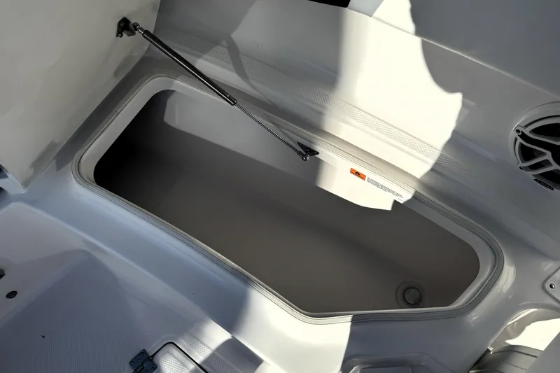 Slide: The Image of 2025 Robalo R270 Center Console storage compartment with open lid and hydraulic support. - 17