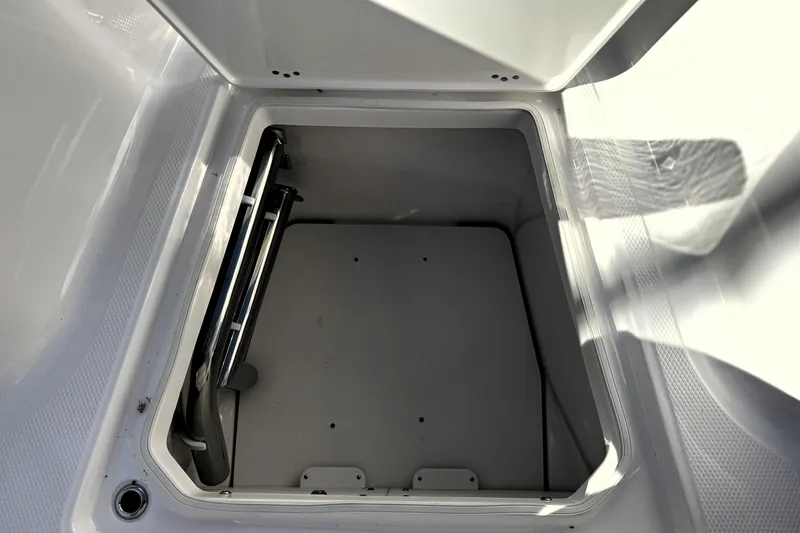 Slide: The Image of Open storage compartment on 2025 Robalo R270 Center Console boat. - 19