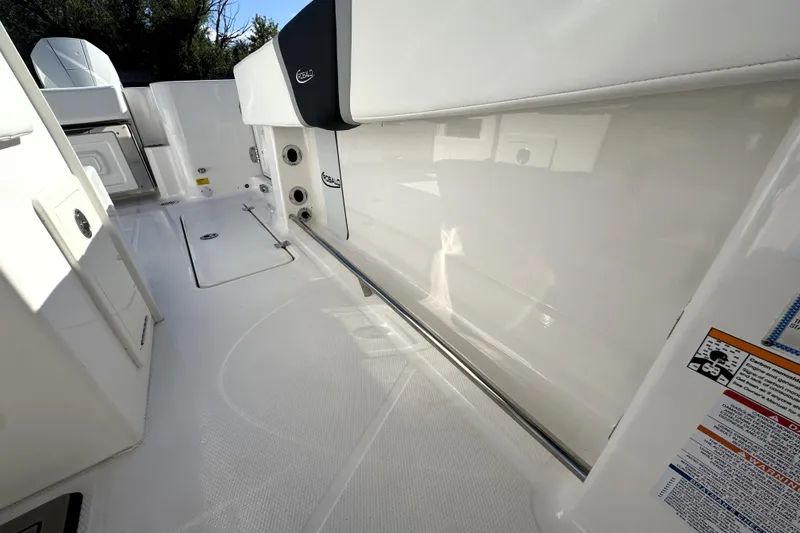 Slide: The Image of 2025 Robalo R270 Center Console boat interior with sleek white design and storage compartments. - 22