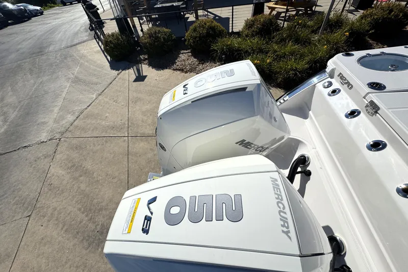 Slide: The Image of 2025 Robalo R270 Center Console with dual Mercury V8 engines, docked outdoors. - 30