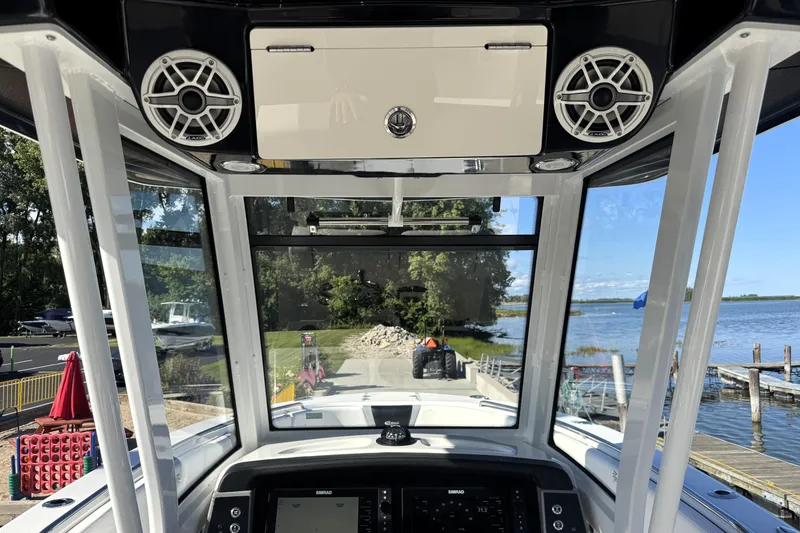 Slide: The Image of 2025 Robalo R270 Center Console boat interior with speakers and navigation system. - 42