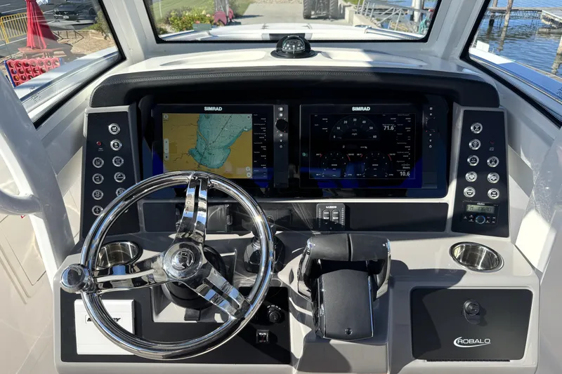 Slide: The Image of 2025 Robalo R270 Center Console dashboard with Simrad navigation system and modern controls. - 43