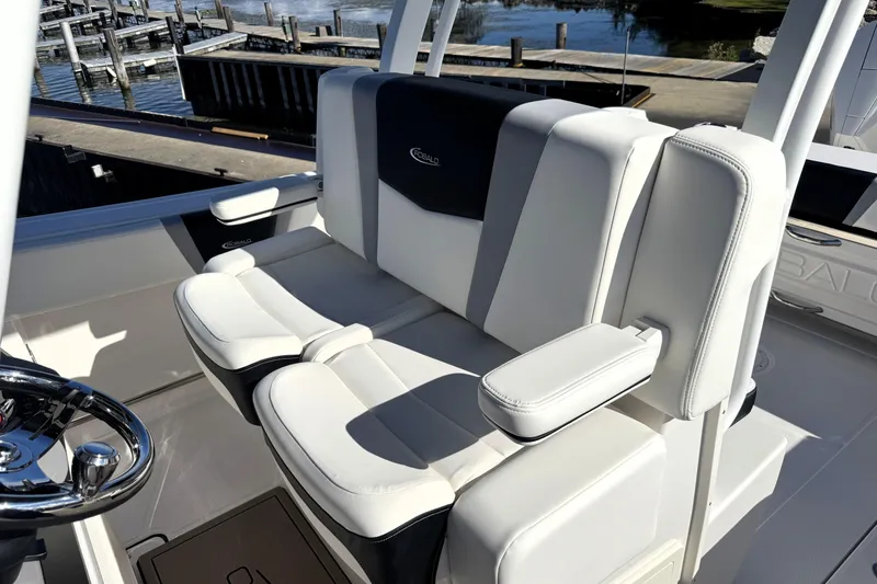 Slide: The Image of 2025 Robalo R270 Center Console boat seating, featuring white cushioned seats and armrests. - 44