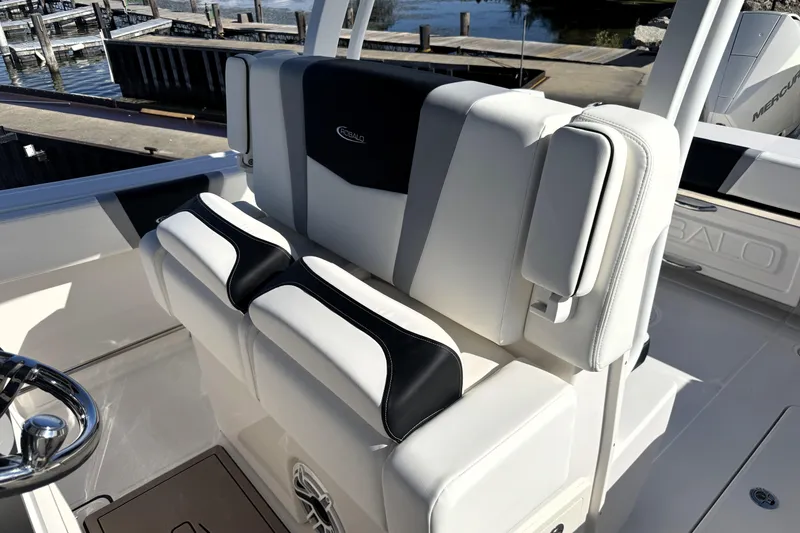 Slide: The Image of 2025 Robalo R270 Center Console boat seating with black and white upholstery. - 45