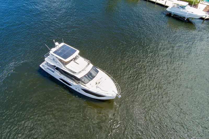 Slide: The Image of Aerial view of 2025 Absolute 52 FLY yacht on calm water. - 11