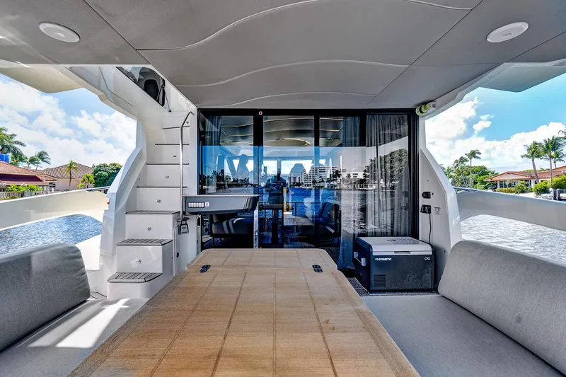 Slide: The Image of Luxurious 2025 Absolute 52 FLY yacht interior with spacious seating and scenic water views. - 12