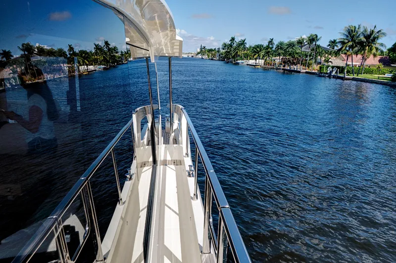 Slide: The Image of Luxury yacht Absolute 52 FLY cruising on a scenic waterway, 2025 model. - 19