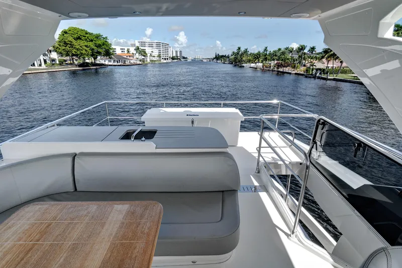 Slide: The Image of Luxurious 2025 Absolute 52 FLY yacht with spacious deck and scenic waterway view. - 26