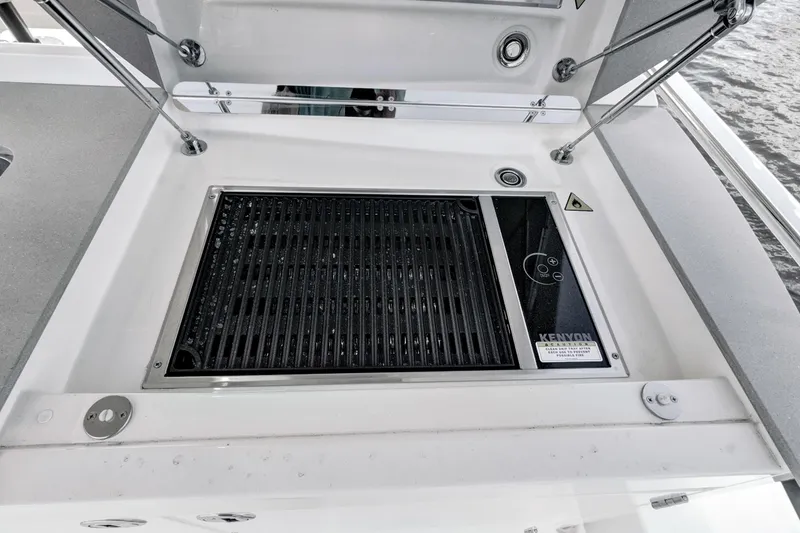 Slide: The Image of Outdoor grill on 2025 Absolute 52 FLY yacht, featuring Kenyon electric cooktop. - 31