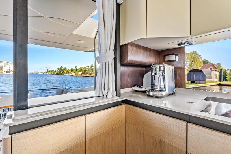 Slide: The Image of Modern kitchen interior on Absolute 52 FLY yacht, featuring sleek cabinetry and scenic water views. - 34