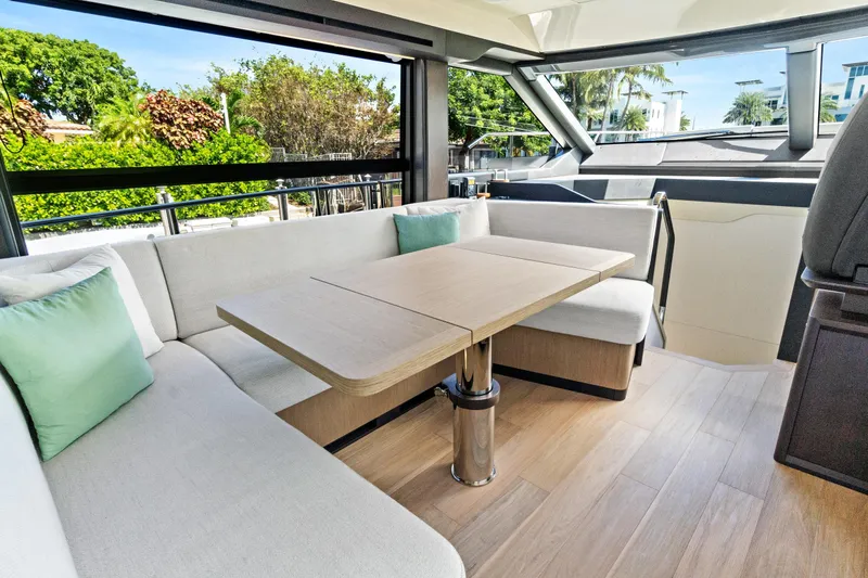 Slide: The Image of Luxurious interior of 2025 Absolute 52 FLY yacht with elegant seating and table. - 39