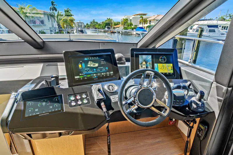 Slide: The Image of Cockpit of 2025 Absolute 52 FLY yacht with advanced navigation displays and controls. - 43
