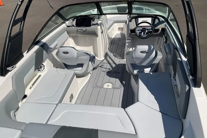 Slide: The Image of 2026 Chaparral 23 SSi OB boat interior with modern seating and steering console. - 17