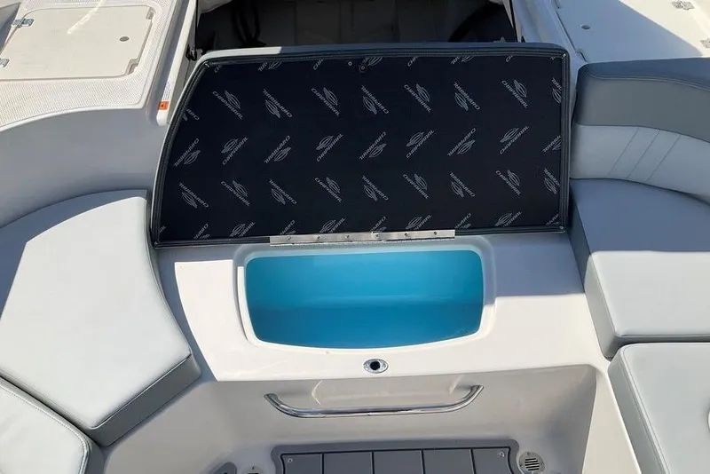 Slide: The Image of 2026 Chaparral 23 SSi OB boat interior with seating and storage compartment. - 24