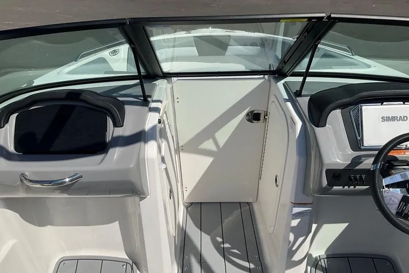 Slide: The Image of 2026 Chaparral 23 SSi OB boat interior with steering wheel and dashboard view. - 31
