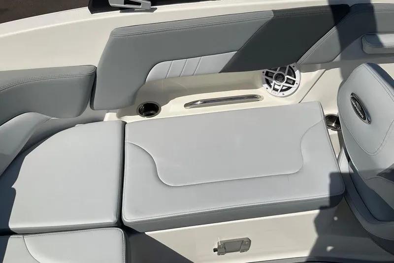 Slide: The Image of 2026 Chaparral 23 SSi OB boat interior with gray seating and speaker. - 33