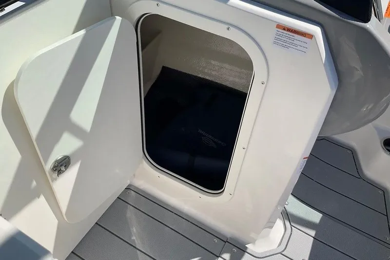 Slide: The Image of Open storage compartment on 2026 Chaparral 23 SSi OB boat deck. - 35