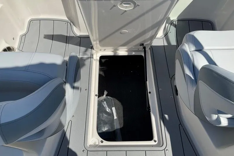 Slide: The Image of 2026 Chaparral 23 SSi OB boat interior with open storage compartment and seating. - 45