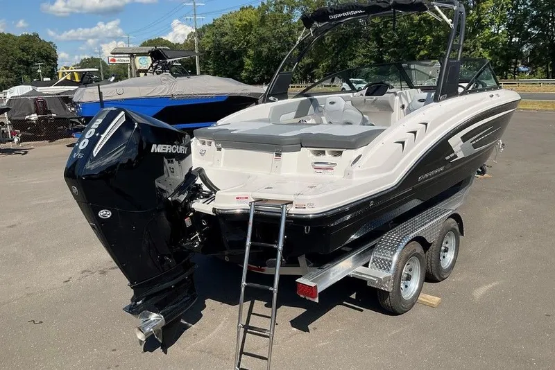 Slide: The Image of 2026 Chaparral 23 SSi OB boat with Mercury engine on trailer, parked outdoors. - 7