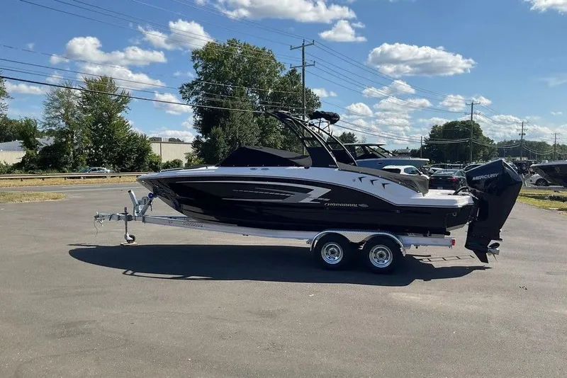 Slide: The Image of 2026 Chaparral 23 SSi OB boat on trailer under clear blue sky. - 8