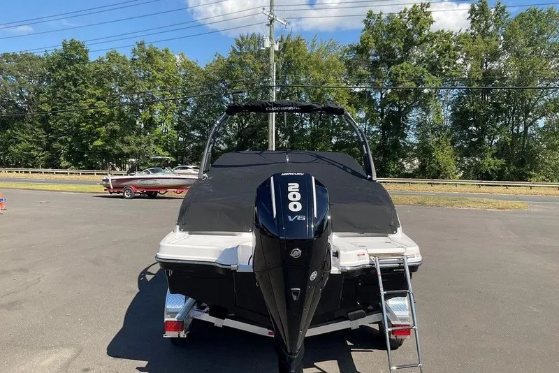 Slide: The Image of 2026 Chaparral 23 SSi OB boat with Mercury 200 V6 engine, parked outdoors. - 9