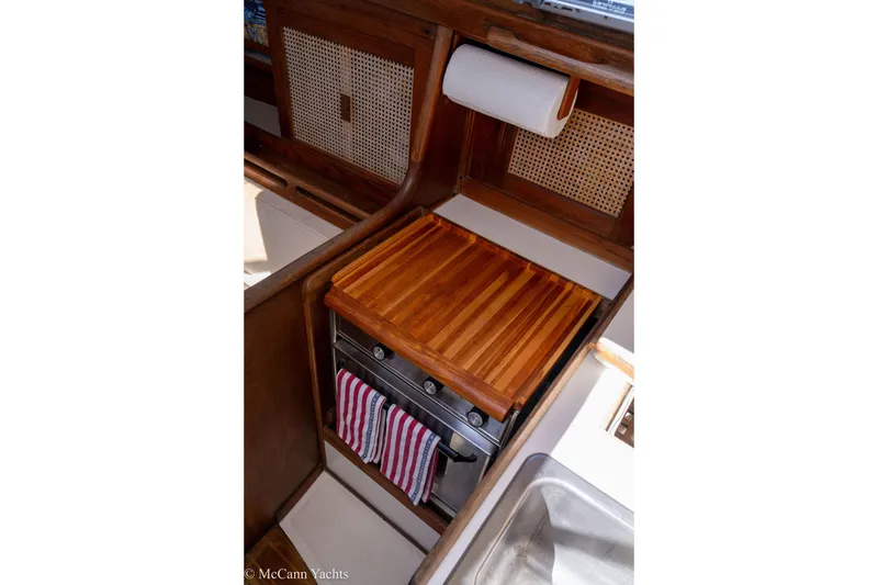 Slide: The Image of Compact galley kitchen in 1985 Tartan 34-2 yacht with wooden countertop and stove. - 13