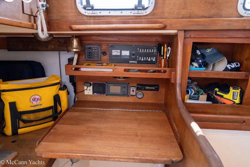 Slide: The Image of 1985 Tartan 34-2 yacht interior with navigation equipment and storage shelves. - 16