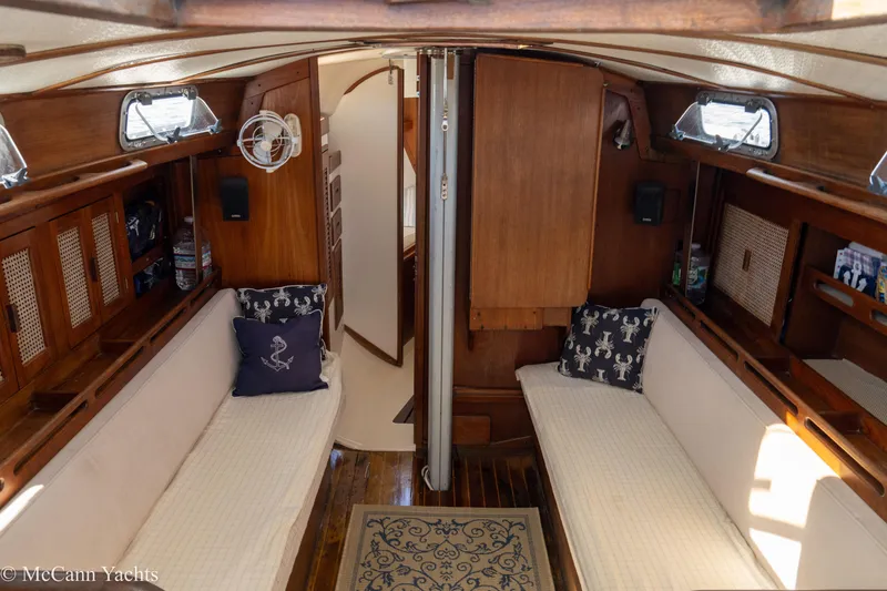 Slide: The Image of Interior of 1985 Tartan 34-2 sailboat with cozy seating and nautical decor. - 17