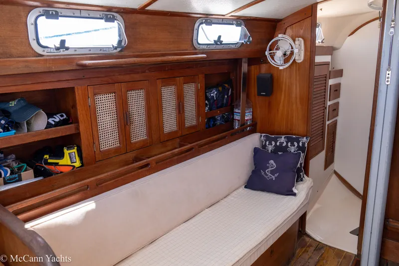Slide: The Image of Interior of 1985 Tartan 34-2 sailboat with wooden cabinetry and cushioned seating. - 20