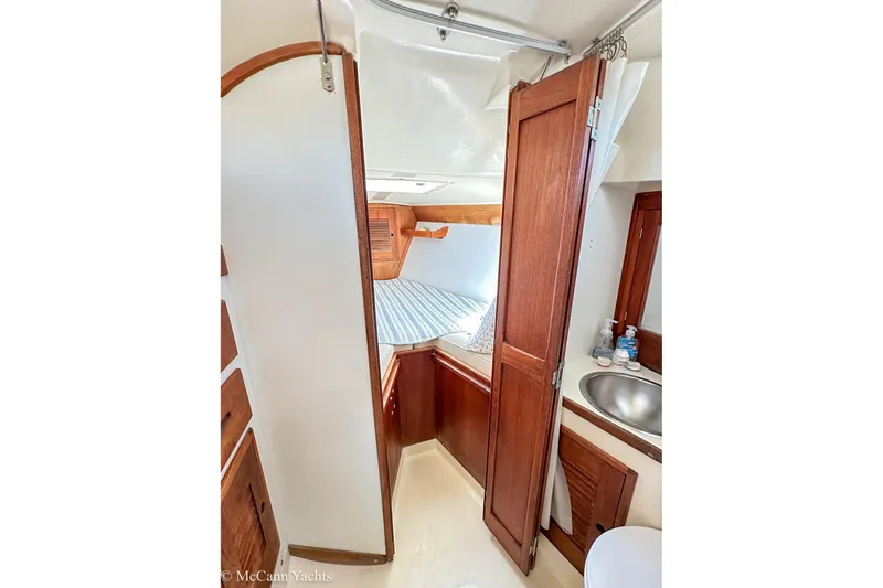 Slide: The Image of Interior of 1985 Tartan 34-2 yacht with wooden cabinetry and compact sink area. - 26