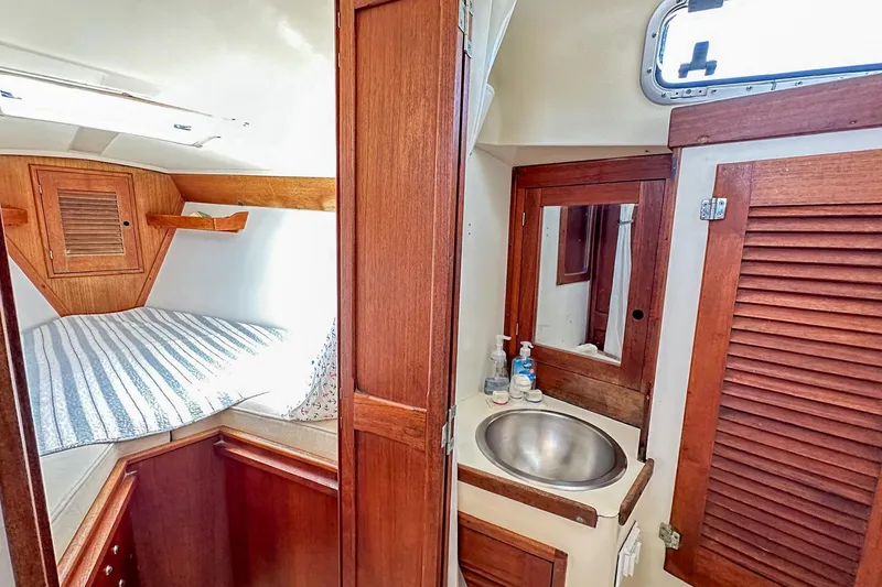 Slide: The Image of 1985 Tartan 34-2 yacht interior with cozy cabin and compact bathroom. - 28