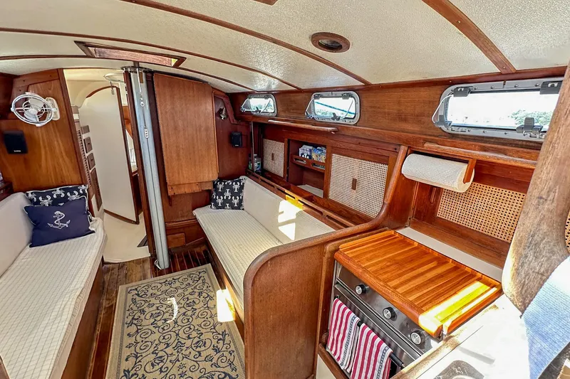 Slide: The Image of Interior of a 1985 Tartan 34-2 sailboat with wooden finishes and cozy seating. - 31