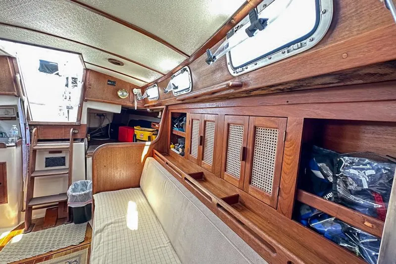 Slide: The Image of Interior of 1985 Tartan 34-2 sailboat with wooden cabinetry and seating area. - 33