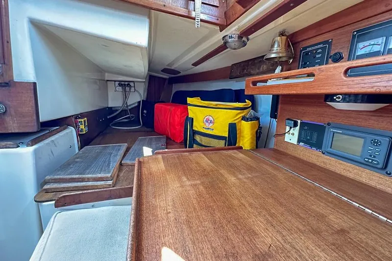 Slide: The Image of Interior of a 1985 Tartan 34-2 sailboat with wooden finishes and navigation equipment. - 35