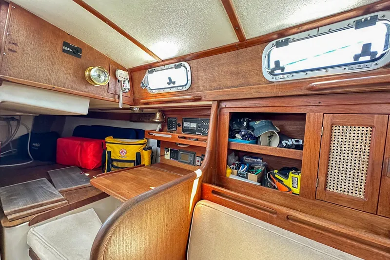 Slide: The Image of Interior of a 1985 Tartan 34-2 sailboat with wooden cabinetry and storage compartments. - 36