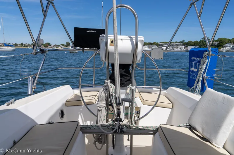 Slide: The Image of Cockpit of 1985 Tartan 34-2 sailboat with steering wheel and seating, on calm water. - 38