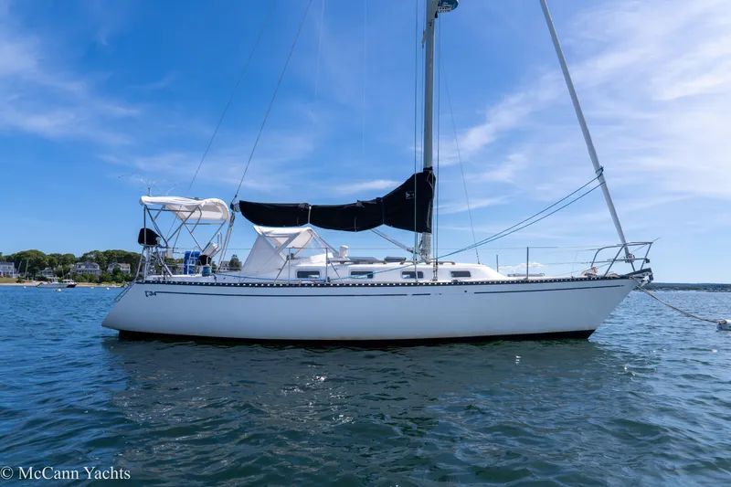 Slide: The Image of 1985 Tartan 34-2 sailboat on calm water under a clear blue sky. - 45