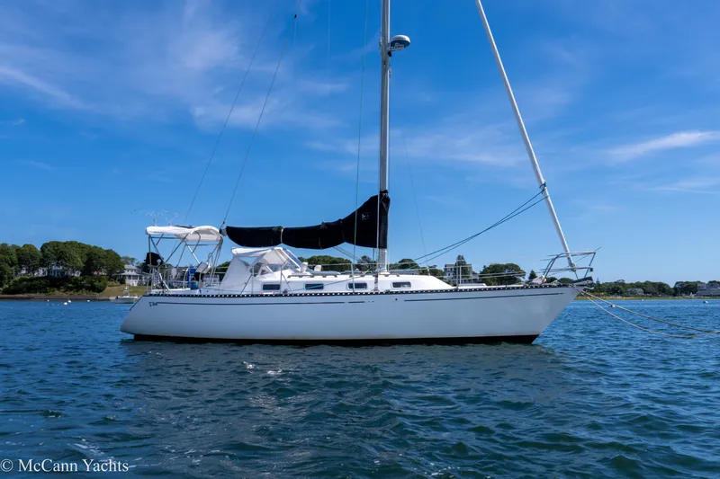 Slide: The Image of 1985 Tartan 34-2 sailboat on calm water under clear blue sky. - 46