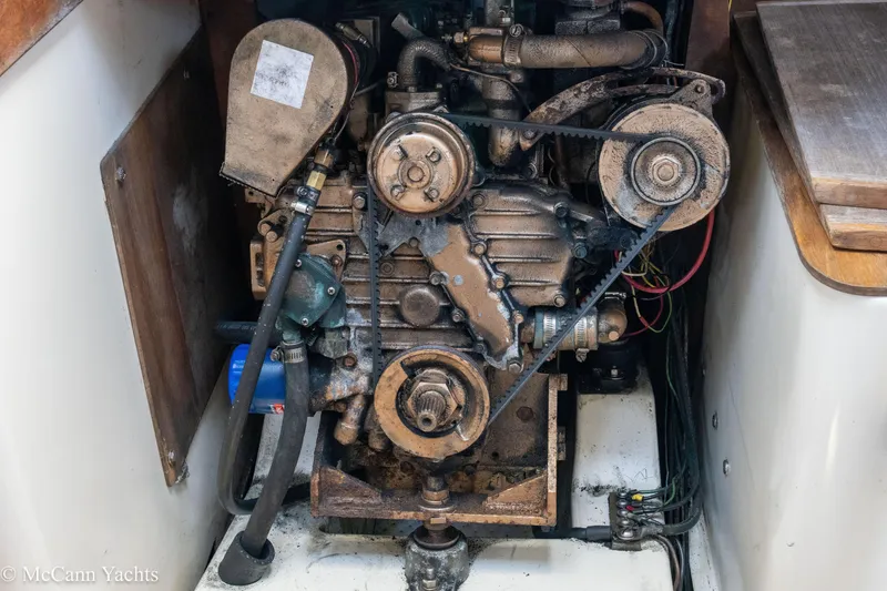 Slide: The Image of Engine compartment of a 1985 Tartan 34-2 sailboat, showing mechanical components and belts. - 50
