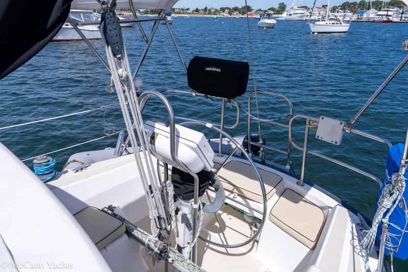 Slide: The Image of Cockpit of 1985 Tartan 34-2 sailboat with steering wheel, moored in a marina. - 6