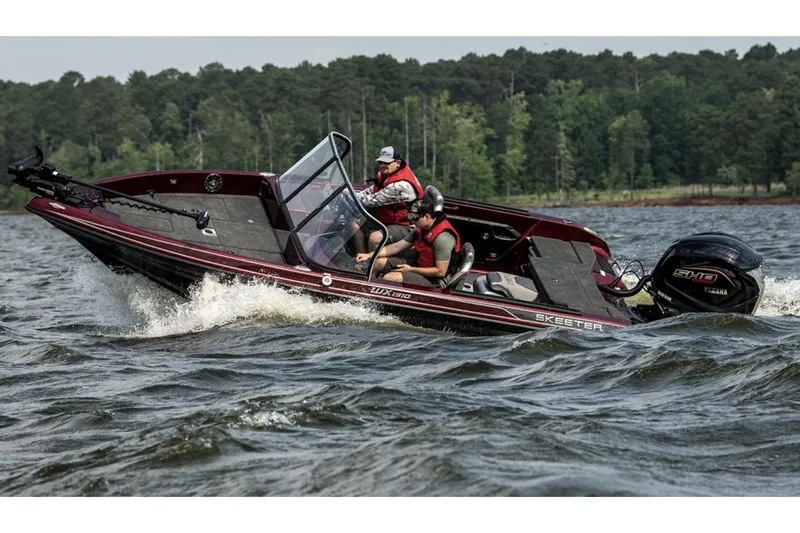 Slide: The Image of 2026 Skeeter WX1910 boat interior with carpeted deck and mounted trolling motor. - 2