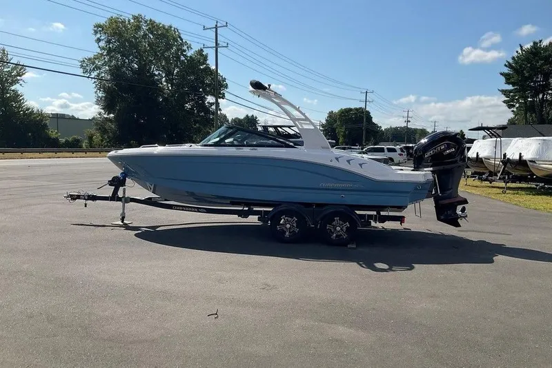 The Image of 2026 Chaparral 21 SSi OB boat on trailer, parked outdoors under clear sky. - 1