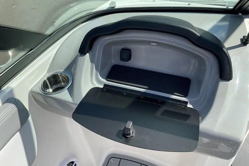 Slide: The Image of 2026 Chaparral 21 SSi OB boat interior with storage compartment and cup holder. - 11