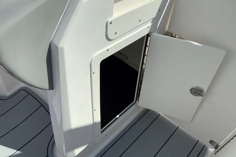 Slide: The Image of Open storage compartment on 2026 Chaparral 21 SSi OB boat interior. - 12