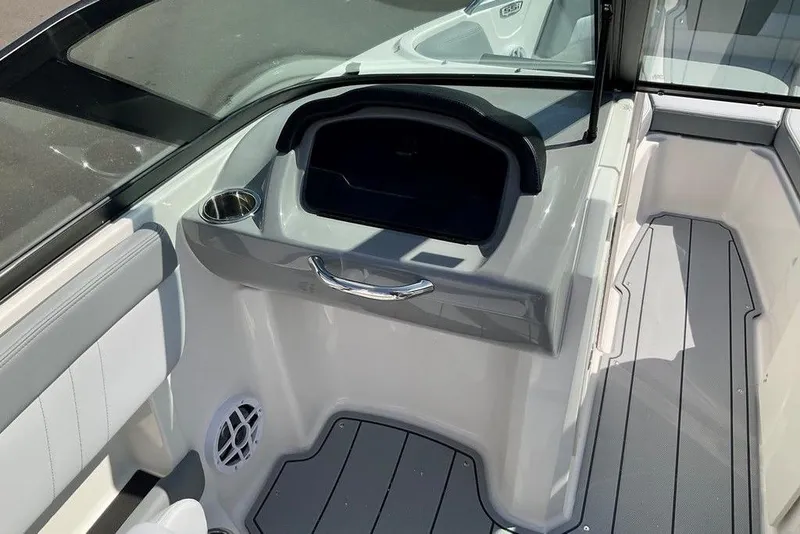 Slide: The Image of 2026 Chaparral 21 SSi OB boat interior with seating, cup holder, and storage compartment. - 16