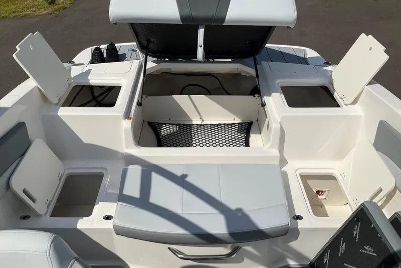 Slide: The Image of 2026 Chaparral 21 SSi OB boat interior with open storage compartments and seating. - 18