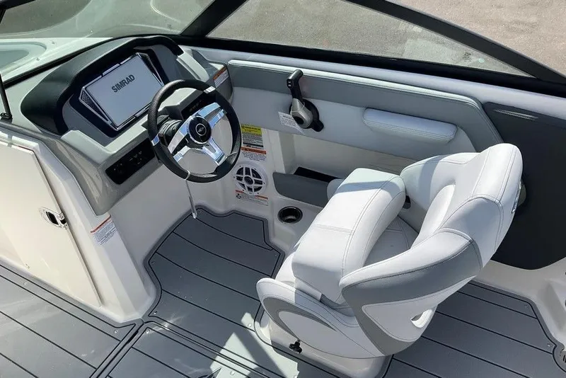 Slide: The Image of 2026 Chaparral 21 SSi OB boat interior with steering wheel and white seating. - 19