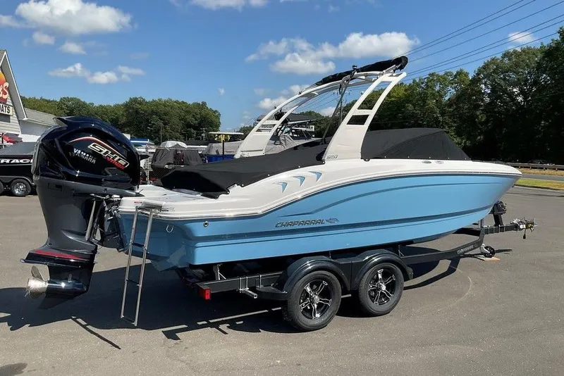 Slide: The Image of 2026 Chaparral 21 SSi OB boat with Yamaha engine on trailer, parked outdoors. - 2