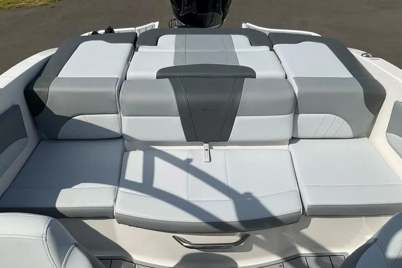 Slide: The Image of 2026 Chaparral 21 SSi OB boat interior with gray and white cushioned seating. - 20