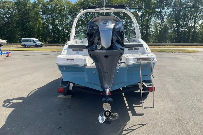 Slide: The Image of 2026 Chaparral 21 SSi OB boat with outboard motor, parked outdoors. - 27